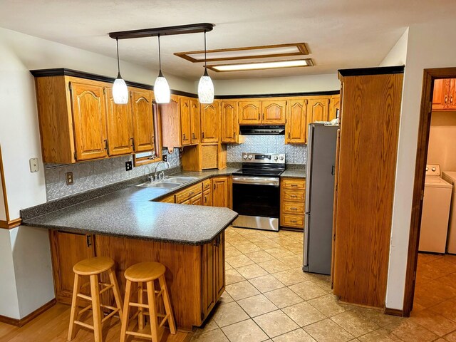912 Domino Ct, Nixa, MO 65714 - kitchen featuring appliances with stainless steel finishes, washer / clothes dryer, extractor fan, a peninsula, and a sink