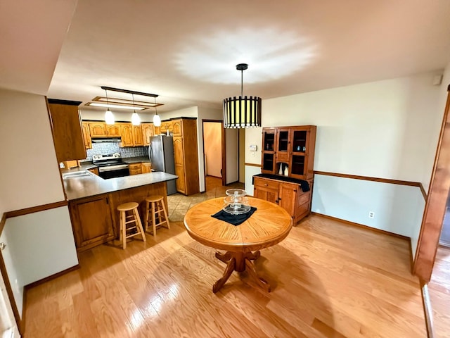 912 Domino Ct, Nixa, MO 65714 - dining room with light wood-style floors and baseboards