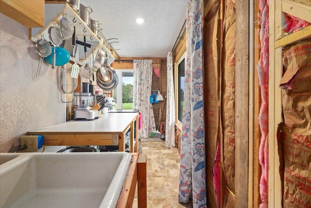 8495 Hwy N, Mountain Grove, MO 65711 - hall featuring a textured wall, a textured ceiling, recessed lighting, and a sink