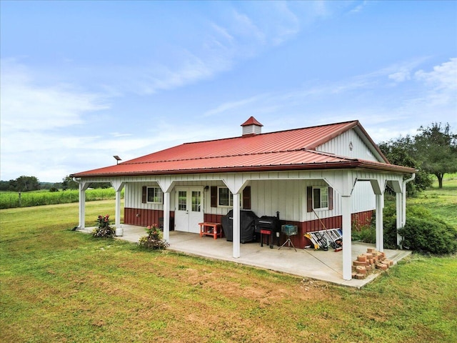8495 Hwy N, Mountain Grove, MO 65711 - rear view of property with a patio area, a yard, board and batten siding, metal roof, and french doors