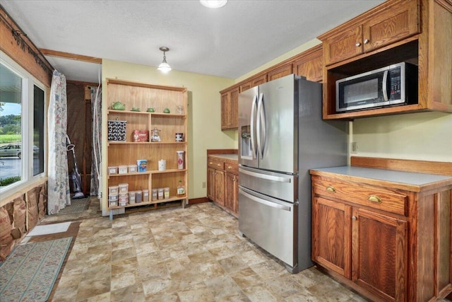 8495 Hwy N, Mountain Grove, MO 65711 - kitchen featuring stainless steel appliances, brown cabinetry, stone finish floors, and hanging light fixtures