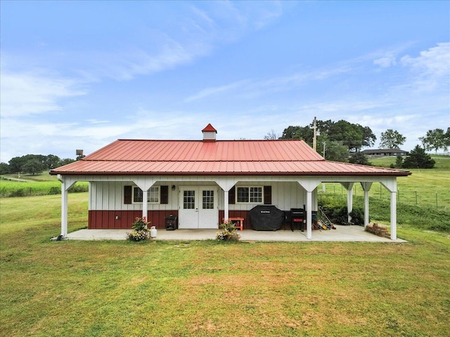 8495 Hwy N, Mountain Grove, MO 65711 - rear view of house with board and batten siding, a patio, a lawn, metal roof, and french doors