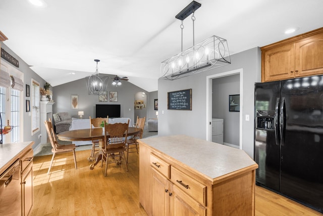 734 N Allison St, Nixa, MO 65714 - kitchen featuring black refrigerator with ice dispenser, a kitchen island, light wood-style flooring, decorative light fixtures, and lofted ceiling