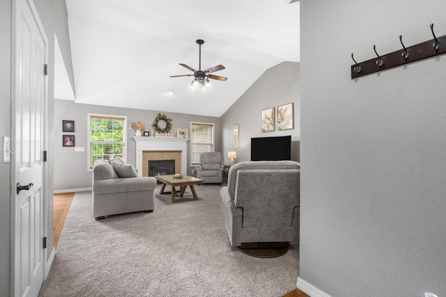 734 N Allison St, Nixa, MO 65714 - living area featuring a ceiling fan, a tiled fireplace, baseboards, lofted ceiling, and carpet floors
