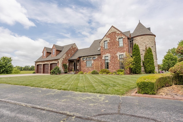 2172 E Farm Road 48, Springfield, MO 65803 - view of front facade with a front lawn, brick siding, driveway, and a garage