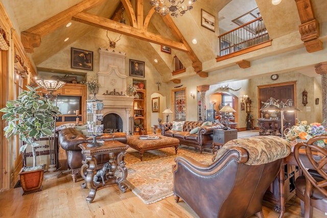 2172 E Farm Road 48, Springfield, MO 65803 - living area featuring high vaulted ceiling, beamed ceiling, wood finished floors, a fireplace, and arched walkways