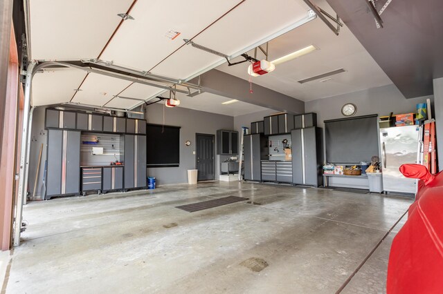 2172 E Farm Road 48, Springfield, MO 65803 - garage featuring a garage door opener and freestanding refrigerator