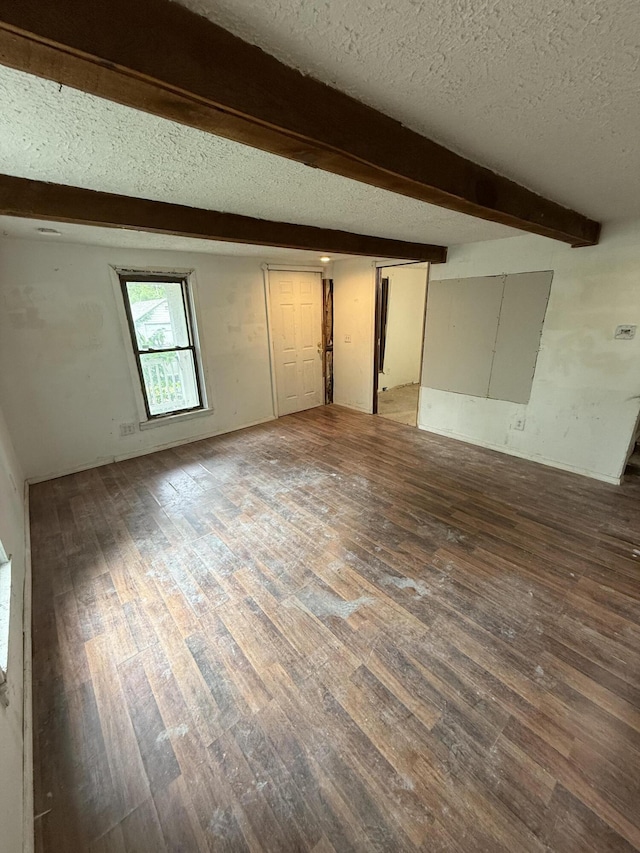 911 W Locust St, Springfield, MO 65803 - unfurnished room featuring a textured ceiling, wood finished floors, and beamed ceiling