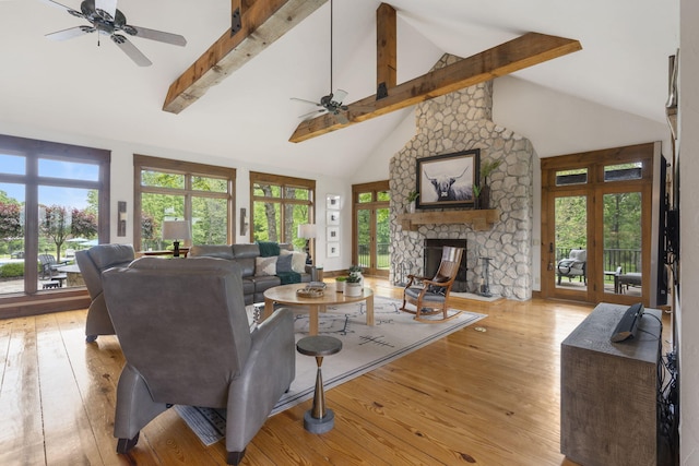 1007 Headwaters Dr, Marshfield, MO 65706 - living room with ceiling fan, high vaulted ceiling, light wood finished floors, a stone fireplace, and beamed ceiling
