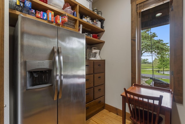 1007 Headwaters Dr, Marshfield, MO 65706 - kitchen featuring stainless steel fridge with ice dispenser, light wood-type flooring, open shelves, and baseboards