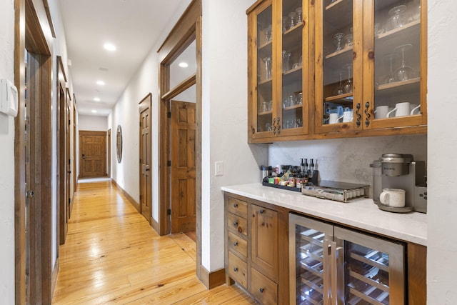 1007 Headwaters Dr, Marshfield, MO 65706 - bar area featuring light wood-style floors, beverage cooler, recessed lighting, and baseboards