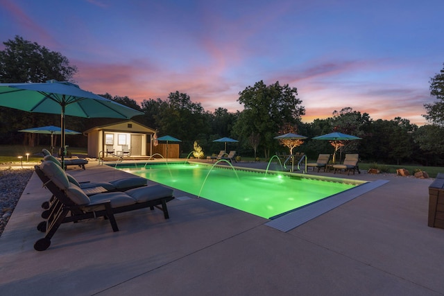 1007 Headwaters Dr, Marshfield, MO 65706 - pool at dusk featuring a patio, an outdoor structure, and an outdoor pool