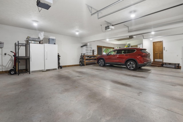1007 Headwaters Dr, Marshfield, MO 65706 - garage featuring a garage door opener and baseboards
