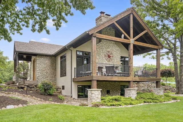 1007 Headwaters Dr, Marshfield, MO 65706 - rear view of house featuring stone siding, a lawn, a chimney, roof with shingles, and a balcony