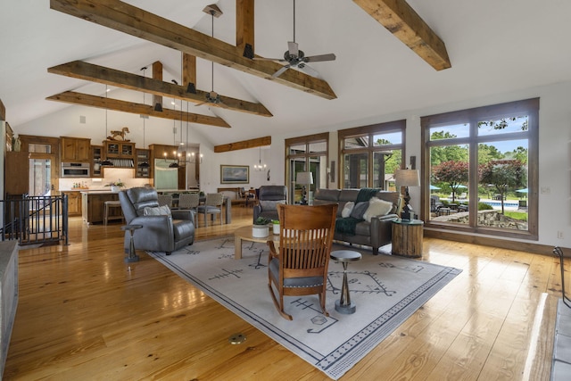 1007 Headwaters Dr, Marshfield, MO 65706 - living area with high vaulted ceiling, beamed ceiling, ceiling fan, and light wood finished floors