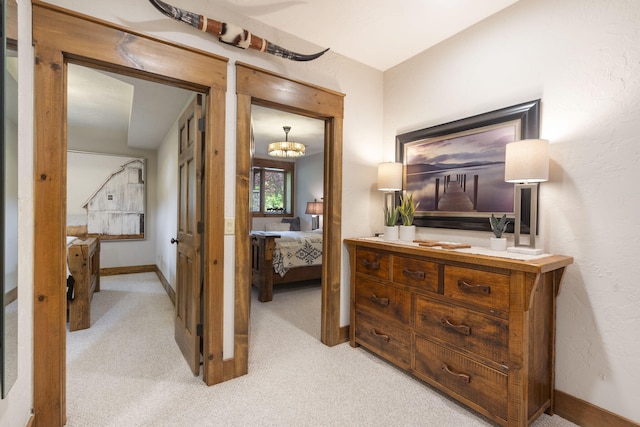1007 Headwaters Dr, Marshfield, MO 65706 - corridor featuring light carpet, baseboards, and a chandelier