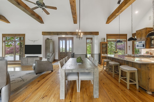 1007 Headwaters Dr, Marshfield, MO 65706 - dining area with beamed ceiling, high vaulted ceiling, light wood-type flooring, and a ceiling fan