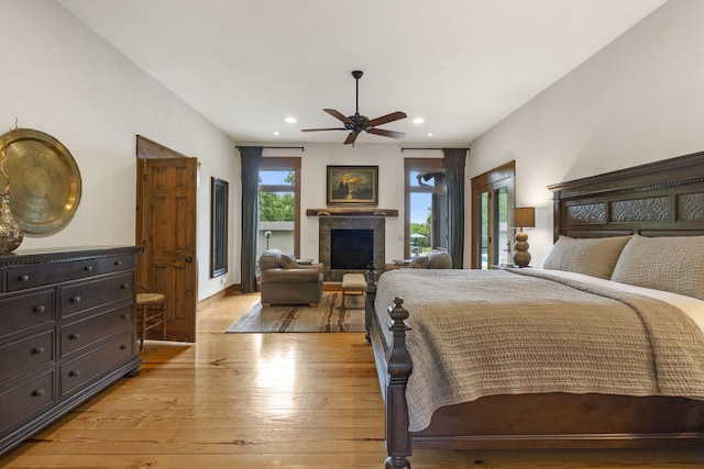 1007 Headwaters Dr, Marshfield, MO 65706 - bedroom featuring light wood finished floors, recessed lighting, a glass covered fireplace, access to outside, and a ceiling fan