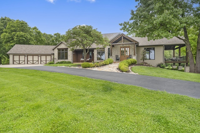 1007 Headwaters Dr, Marshfield, MO 65706 - view of front of home featuring driveway, a front lawn, an attached garage, and french doors