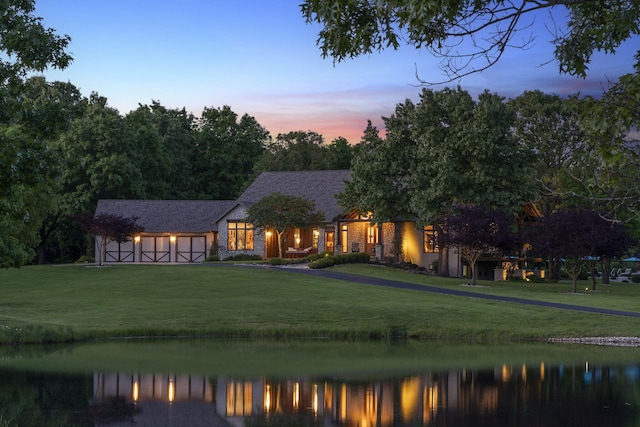 1007 Headwaters Dr, Marshfield, MO 65706 - back of property at dusk featuring a yard, a water view, and driveway