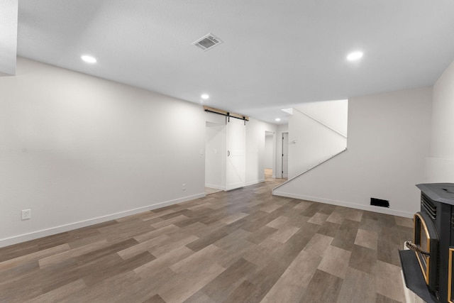 25609 Hillcrest Dr, Shell Knob, MO 65747 - finished below grade area with a barn door, recessed lighting, light wood-style floors, and baseboards