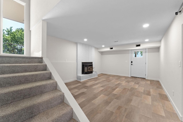 25609 Hillcrest Dr, Shell Knob, MO 65747 - basement featuring stairway, recessed lighting, light wood finished floors, baseboards, and a wood stove