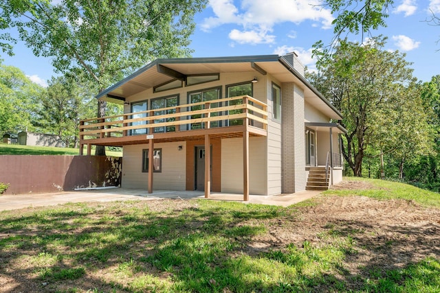 25609 Hillcrest Dr, Shell Knob, MO 65747 - view of front of house featuring a chimney and a patio area