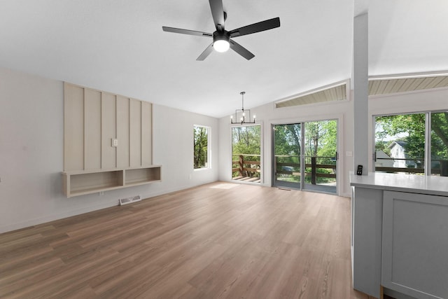 25609 Hillcrest Dr, Shell Knob, MO 65747 - unfurnished living room with lofted ceiling, a chandelier, a ceiling fan, and light wood finished floors
