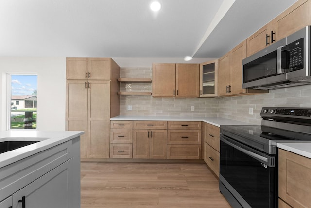 25609 Hillcrest Dr, Shell Knob, MO 65747 - kitchen featuring appliances with stainless steel finishes, light countertops, light wood-style flooring, open shelves, and tasteful backsplash