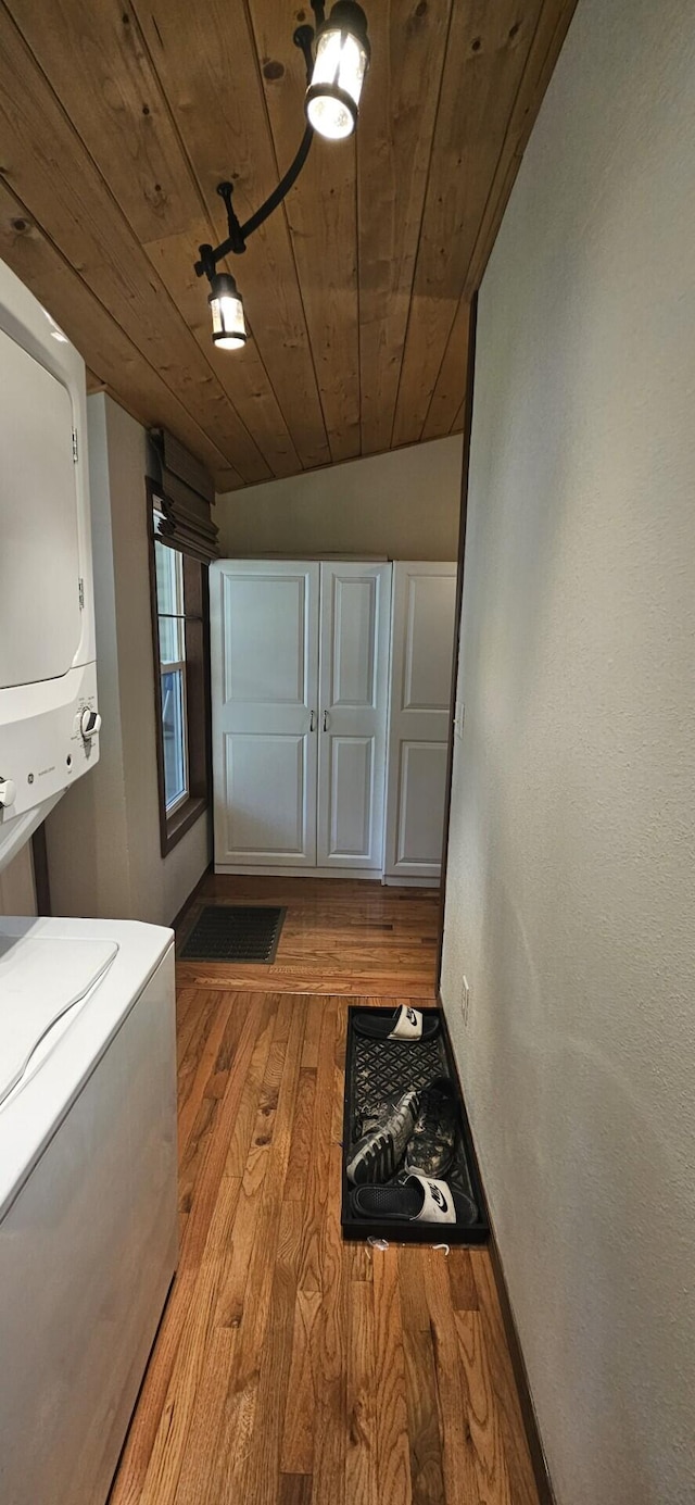 182 Cathy St, Branson, MO 65616 - doorway with estacked washer and dryer, light wood-style flooring, and wooden ceiling