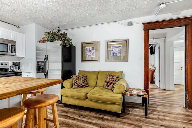 1200 E Walnut St, Springfield, MO 65802 - living room featuring wood finished floors and a textured ceiling