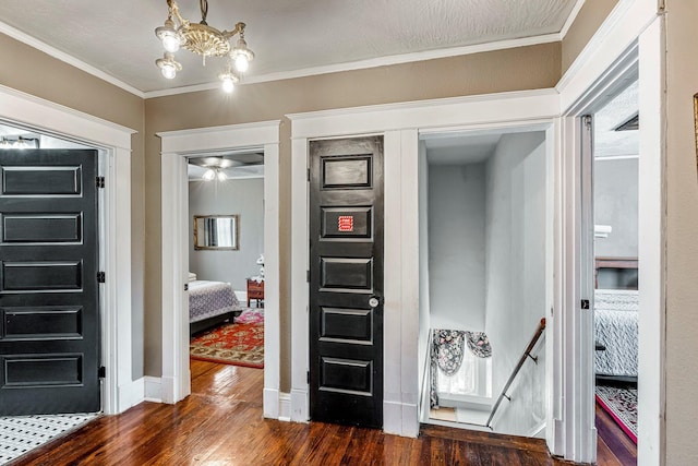 1200 E Walnut St, Springfield, MO 65802 - entrance foyer with dark wood-style flooring, a chandelier, crown molding, baseboards, and a ceiling fan