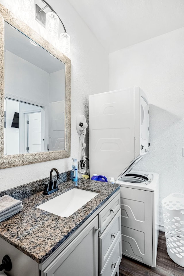 1200 E Walnut St, Springfield, MO 65802 - bathroom featuring wood finished floors, vanity, and a textured wall