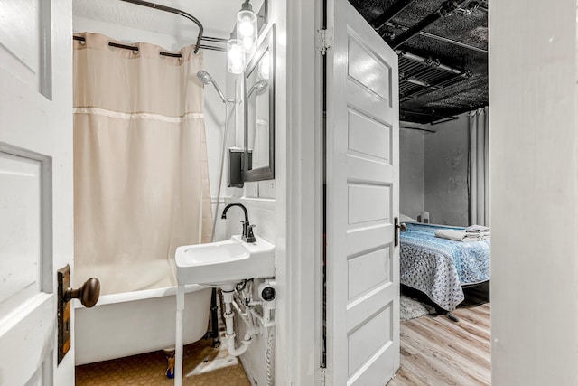 1200 E Walnut St, Springfield, MO 65802 - full bath featuring shower / bath combination with curtain, connected bathroom, a sink, and wood finished floors