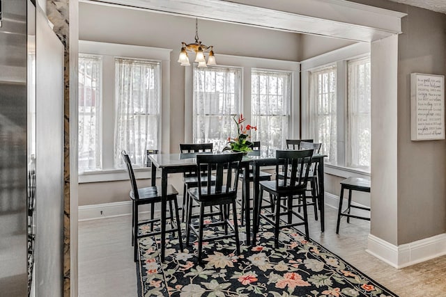 1200 E Walnut St, Springfield, MO 65802 - dining room with a chandelier, baseboards, and wood finished floors