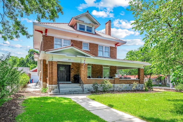 1200 E Walnut St, Springfield, MO 65802 - traditional style home featuring a chimney, a porch, a front lawn, and brick siding