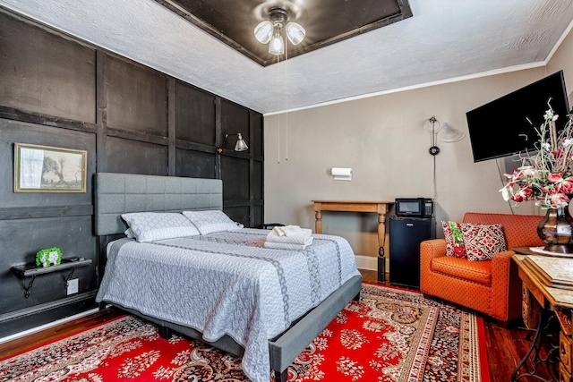 1200 E Walnut St, Springfield, MO 65802 - bedroom featuring wood finished floors, fridge, and ornamental molding