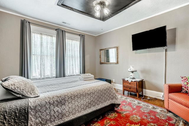 1200 E Walnut St, Springfield, MO 65802 - bedroom featuring wood finished floors, baseboards, and crown molding