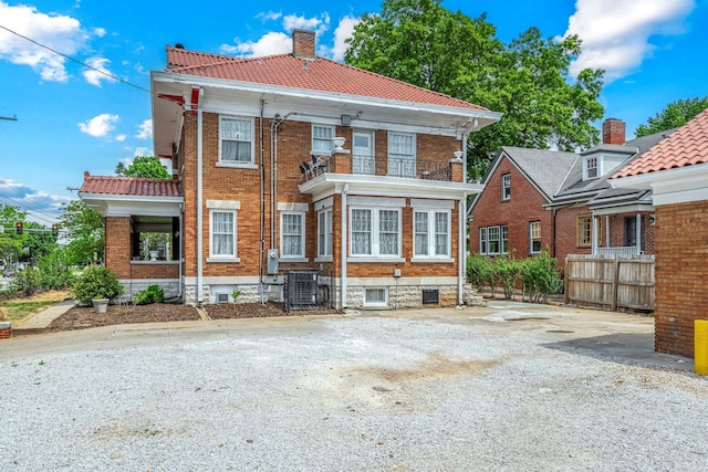 1200 E Walnut St, Springfield, MO 65802 - back of house with a balcony, brick siding, central AC, and a chimney