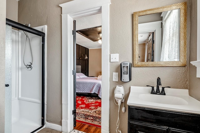 1200 E Walnut St, Springfield, MO 65802 - bathroom featuring a textured wall, a shower stall, ensuite bathroom, wood finished floors, and vanity