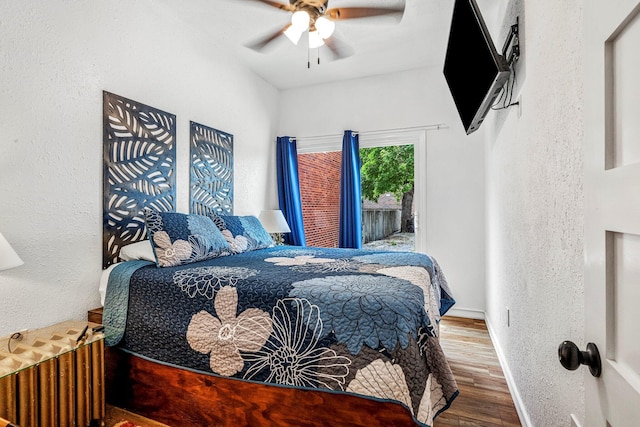 1200 E Walnut St, Springfield, MO 65802 - bedroom featuring wood finished floors, baseboards, a textured wall, a ceiling fan, and access to outside