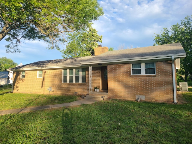 511 3rd St, Mccune, MO 66753 - single story home featuring a chimney, a front lawn, brick siding, roof with shingles, and crawl space