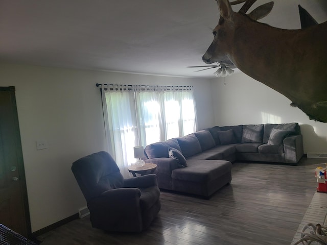 511 3rd St, Mccune, MO 66753 - living area featuring ceiling fan, dark wood-style floors, and baseboards