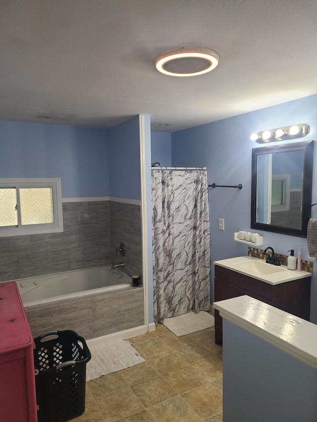 511 3rd St, Mccune, MO 66753 - bathroom featuring vanity, tiled bath, and a shower with shower curtain