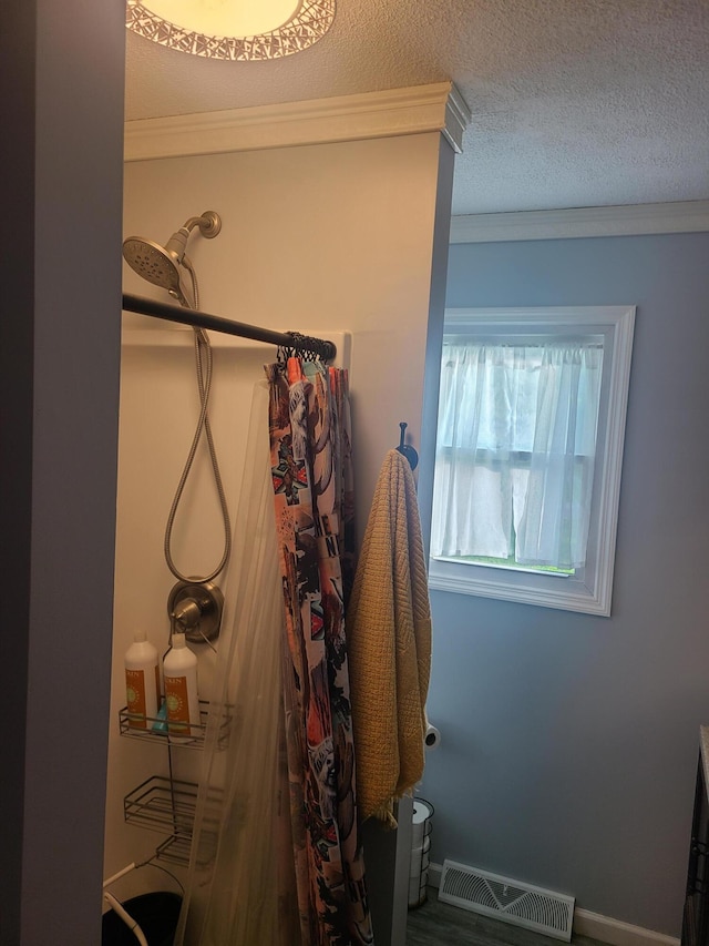 511 3rd St, Mccune, MO 66753 - full bathroom featuring a shower with curtain, ornamental molding, and a textured ceiling