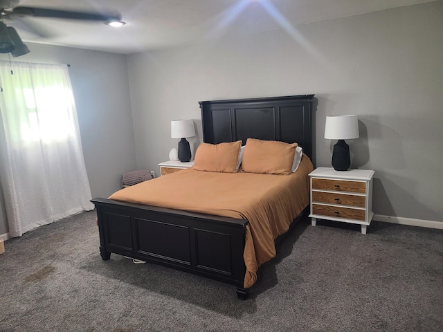 511 3rd St, Mccune, MO 66753 - bedroom with dark colored carpet, ceiling fan, and baseboards