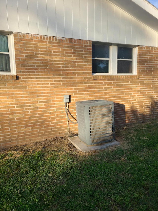 511 3rd St, Mccune, MO 66753 - exterior view of cooling unit and brick siding