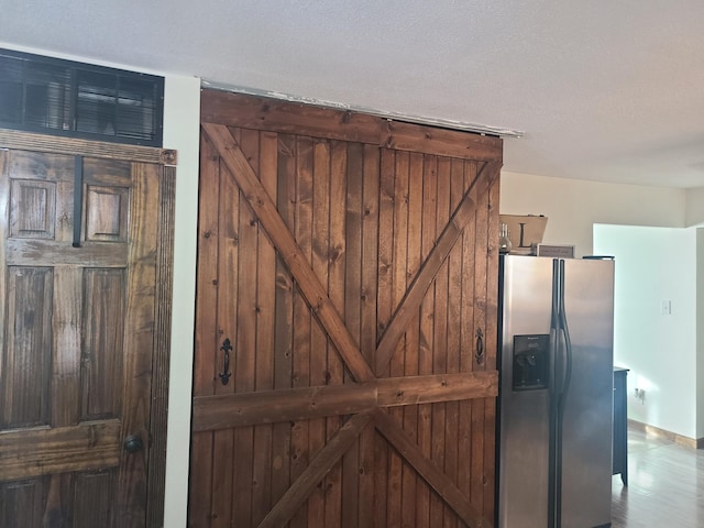 511 3rd St, Mccune, MO 66753 - detailed view of stainless steel fridge and a barn door