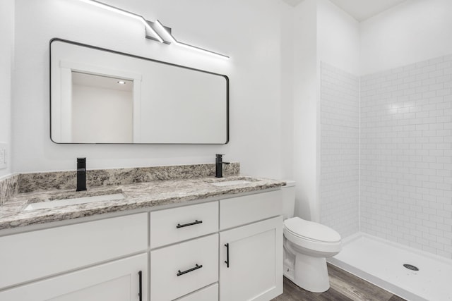 806 Iris Ave, Crane, MO 65633 - full bath with toilet, double vanity, a stall shower, and wood finished floors