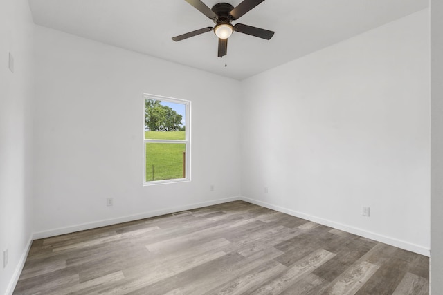 806 Iris Ave, Crane, MO 65633 - unfurnished room featuring wood finished floors, baseboards, and ceiling fan